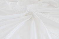 Sateen organic cotton sheet in white cotton fabric, highlighting its soft and luxurious appearance.
